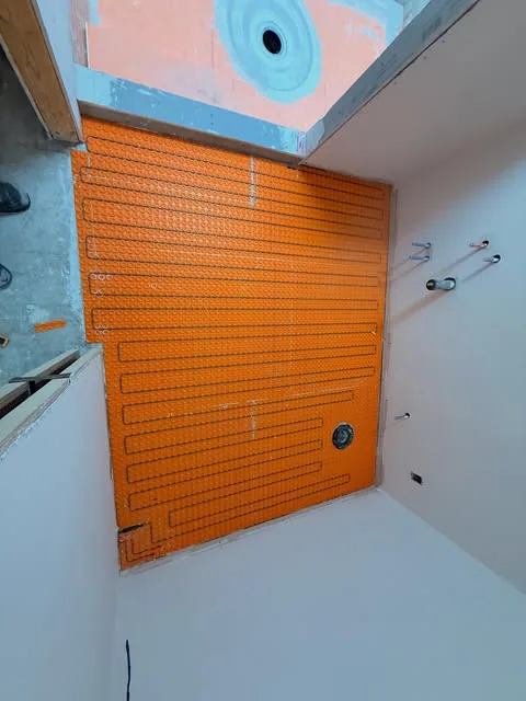 Waterproofing and tile preparation in progress