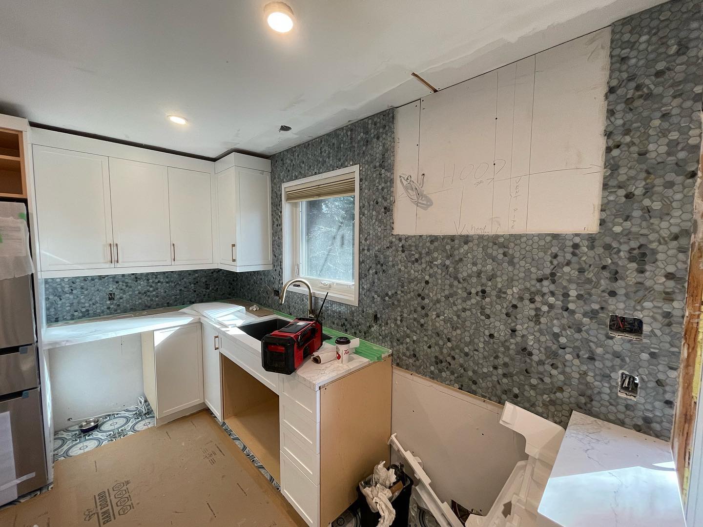 Kitchen renovation during cabinet, counter, backsplash, and electrical installation